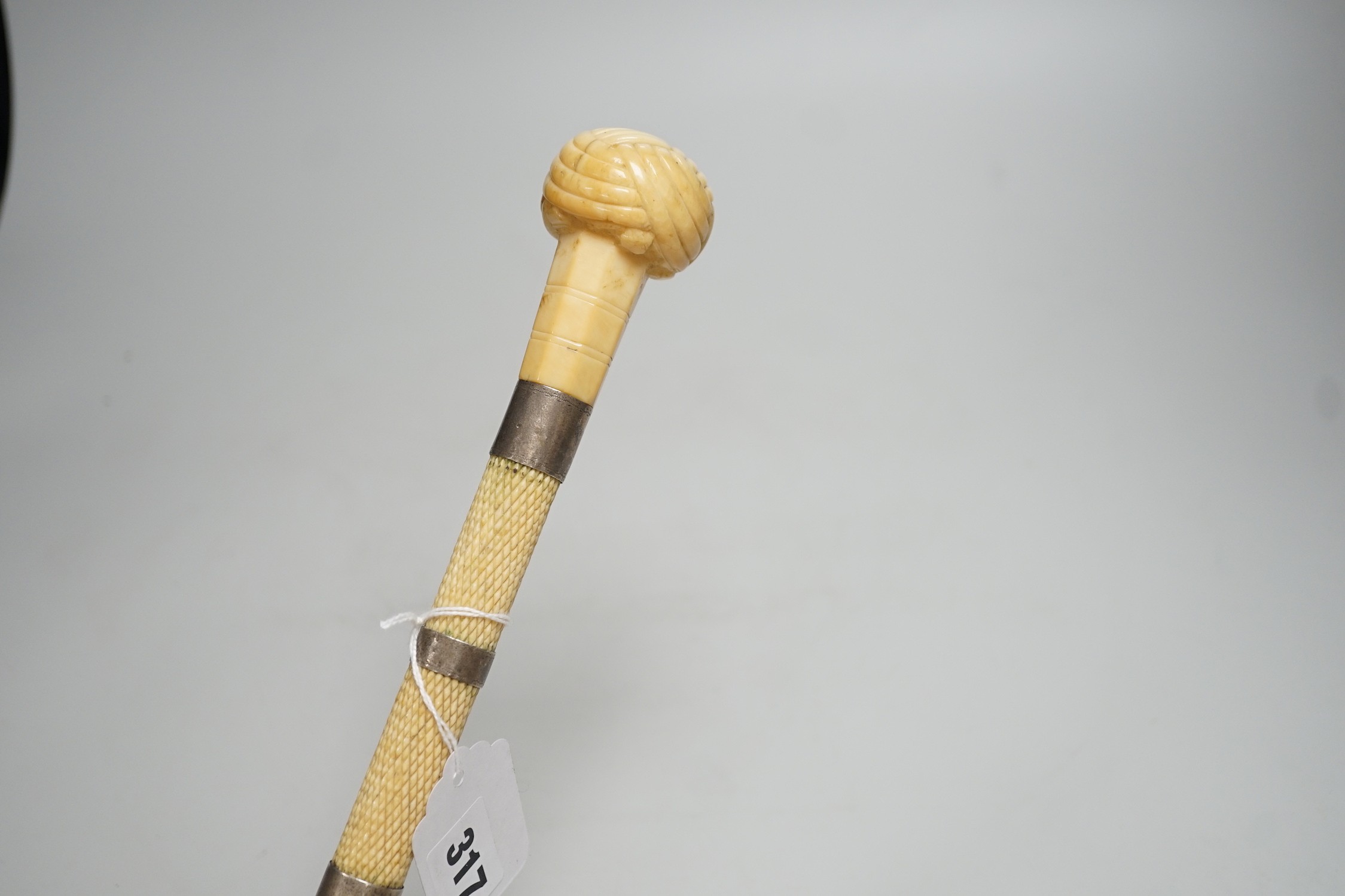 A 19th century scrimshaw whalebone walking cane with white metal mounts, length 69cm